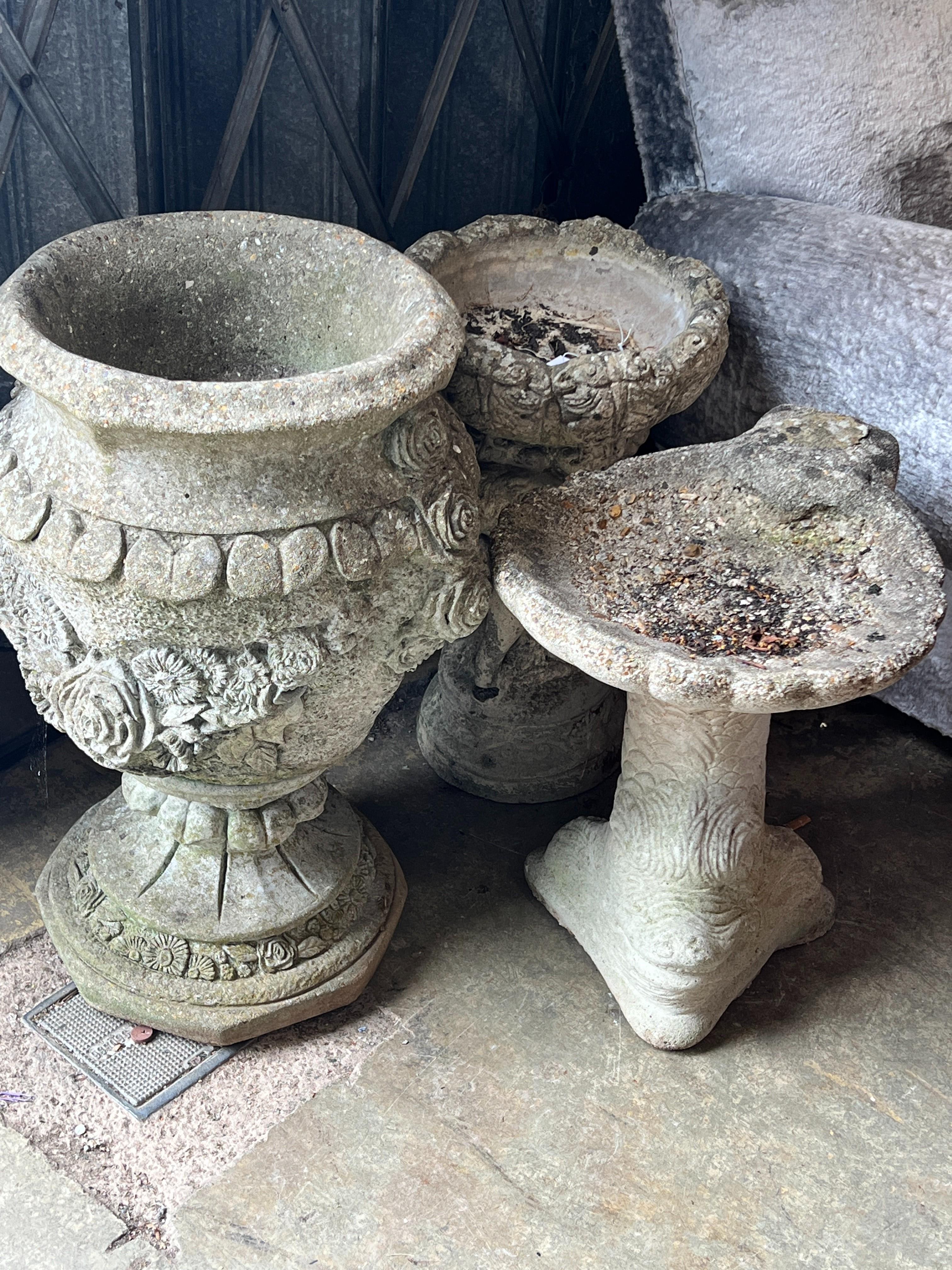 A reconstituted stone garden urn, height 63cm together with two stone bird baths